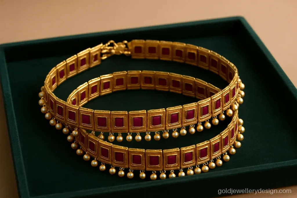 Bridal gold payal with wide ruby panels and small pearl drops