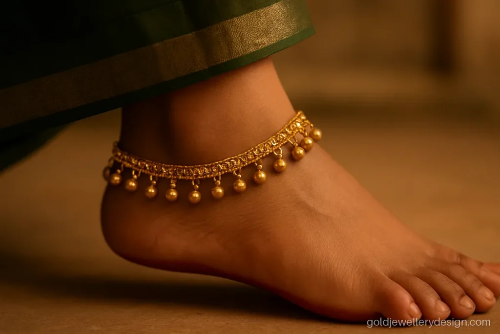 Gold payal design with a fine chain and small ghungroo bells along the edge