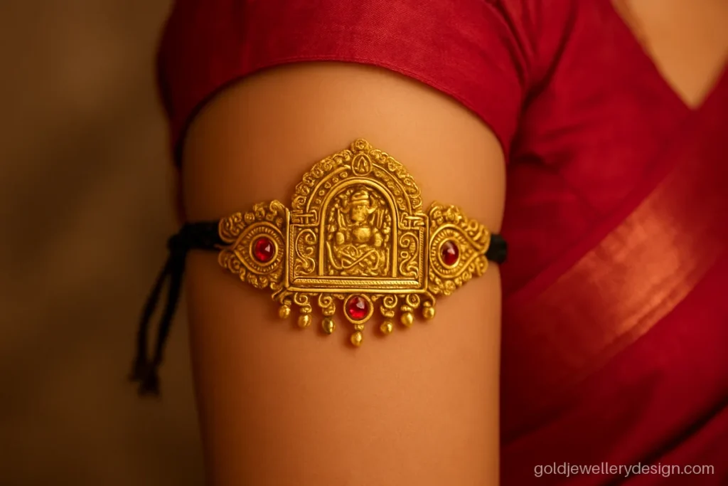 Bridal gold bajuband with a temple arch centre, rubies and a black silk dori
