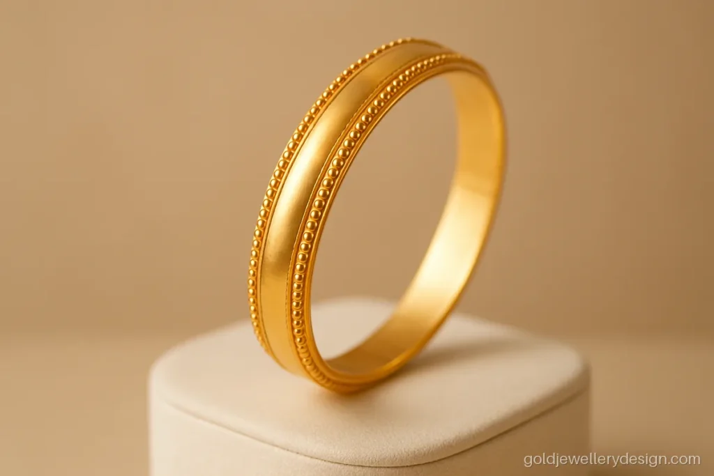 Bangle design gold with a plain centre and tiny beaded borders