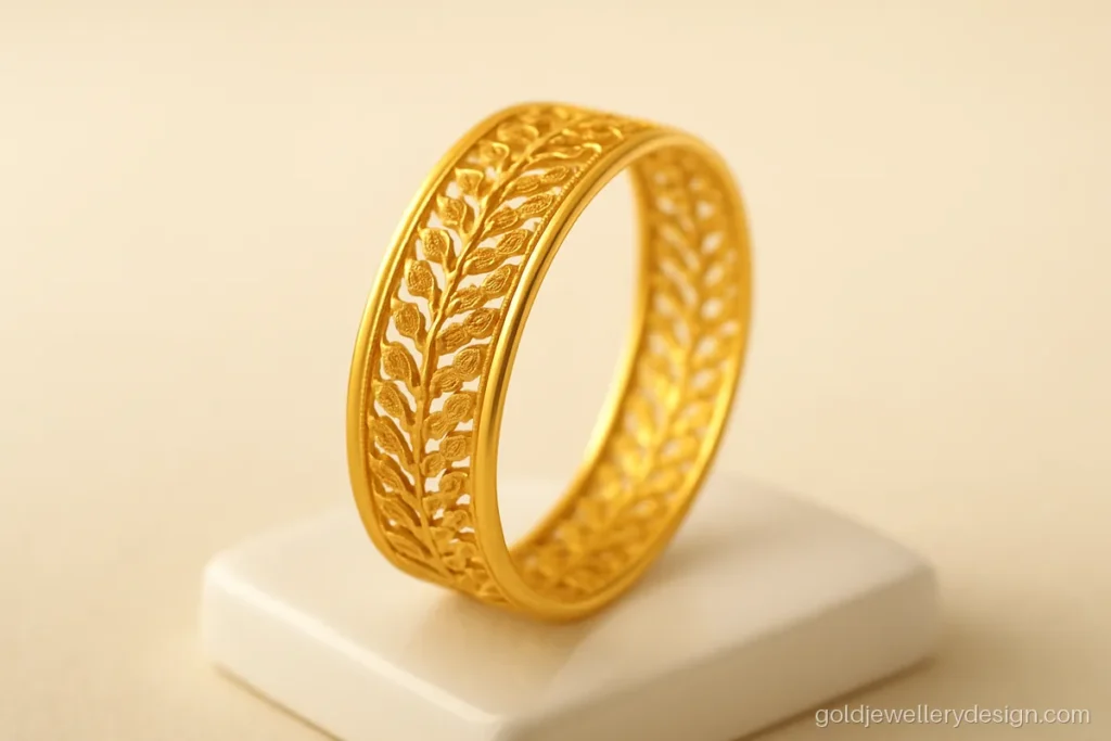 Light gold bangle with open jali cut-work of small leaves