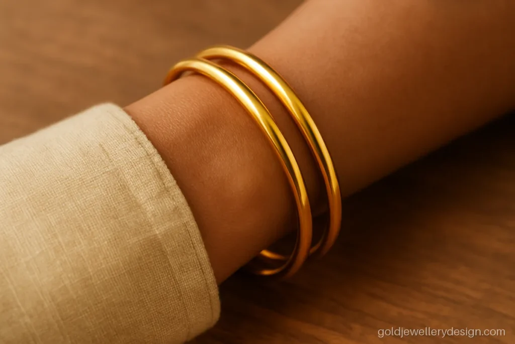 Daily wear gold bangles design, a plain round solid pair with soft polish
