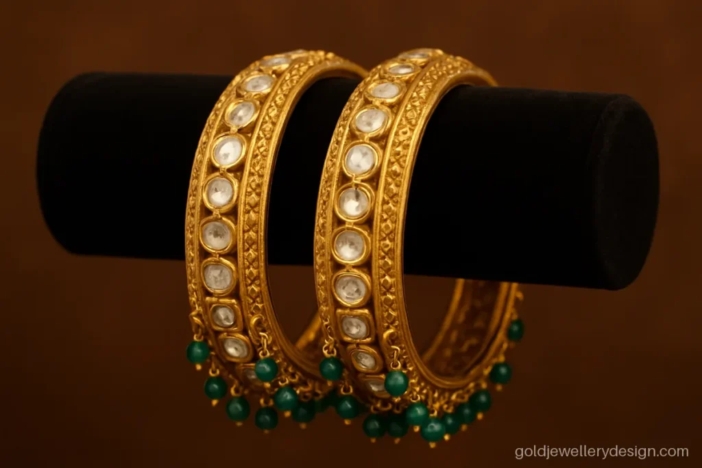 Wedding gold bangles design with polki-look uncut stones in a broad band