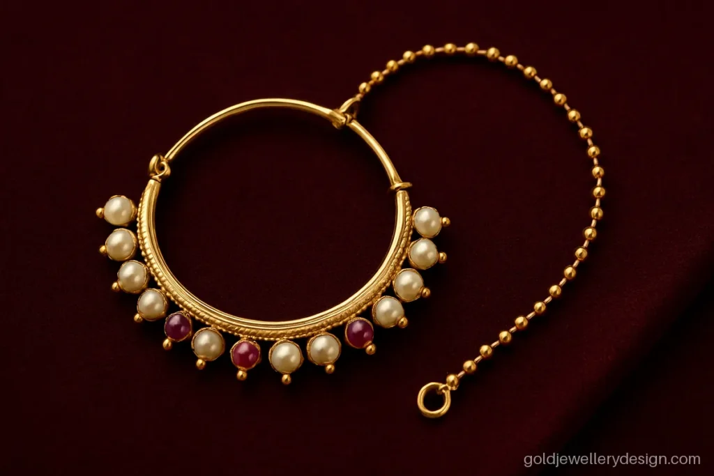Bengali gold nose ring design, a large round noth with pearls and a hair chain