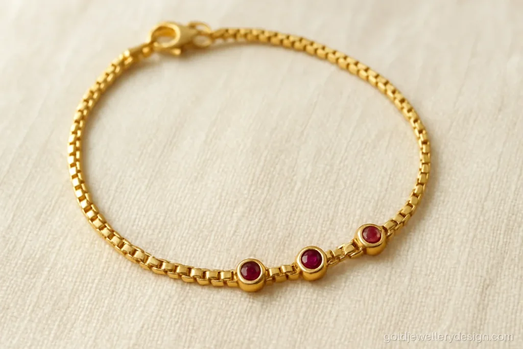 Gold bracelet design for women, a fine box chain with three tiny ruby stations