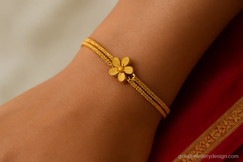 Ladies bracelet gold design with two fine rope strands joined at a flower clasp