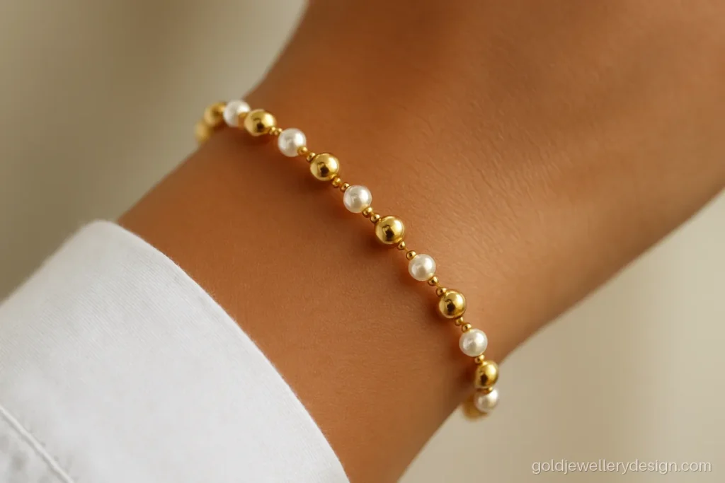 Design of gold bracelet for female students with small gold balls and creamy pearls