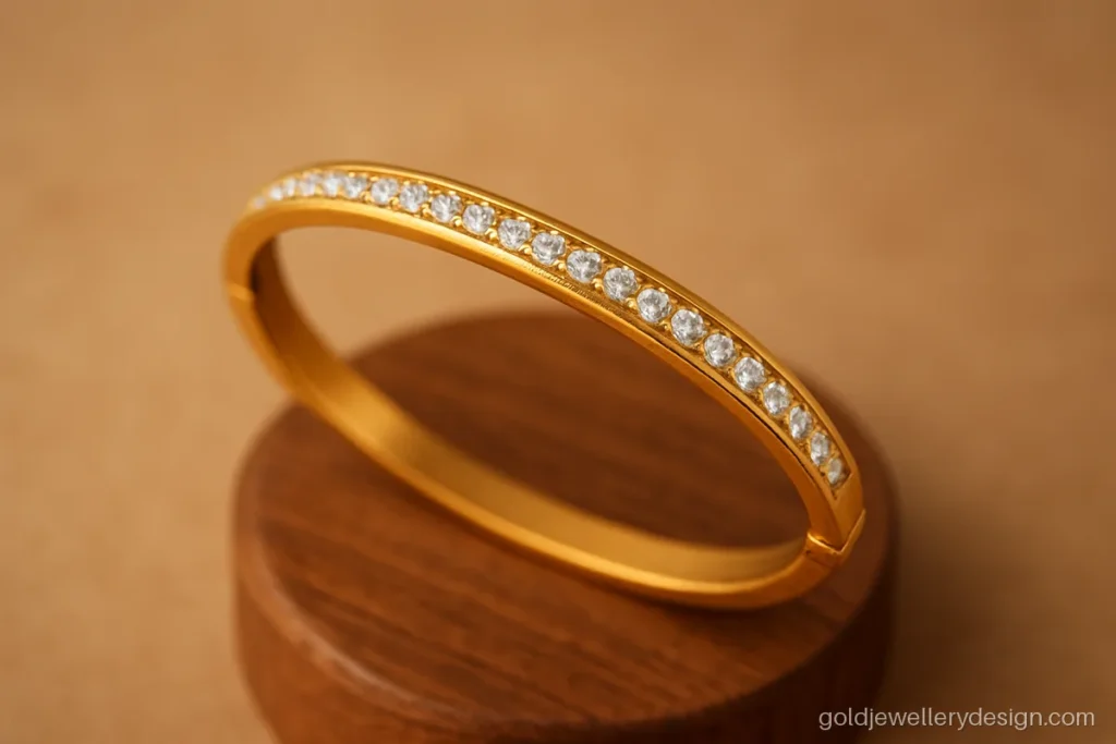 Bracelet bangle gold design with a hinged opening and a row of white CZ