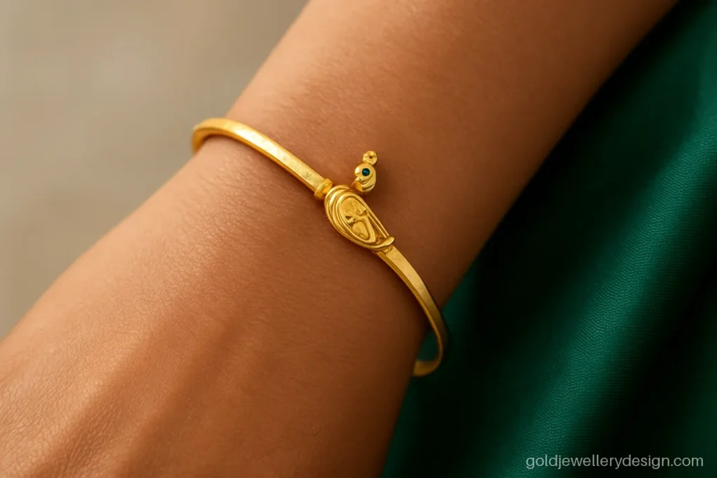 Gold bracelet for women design, a slim bangle bracelet with a peacock centre