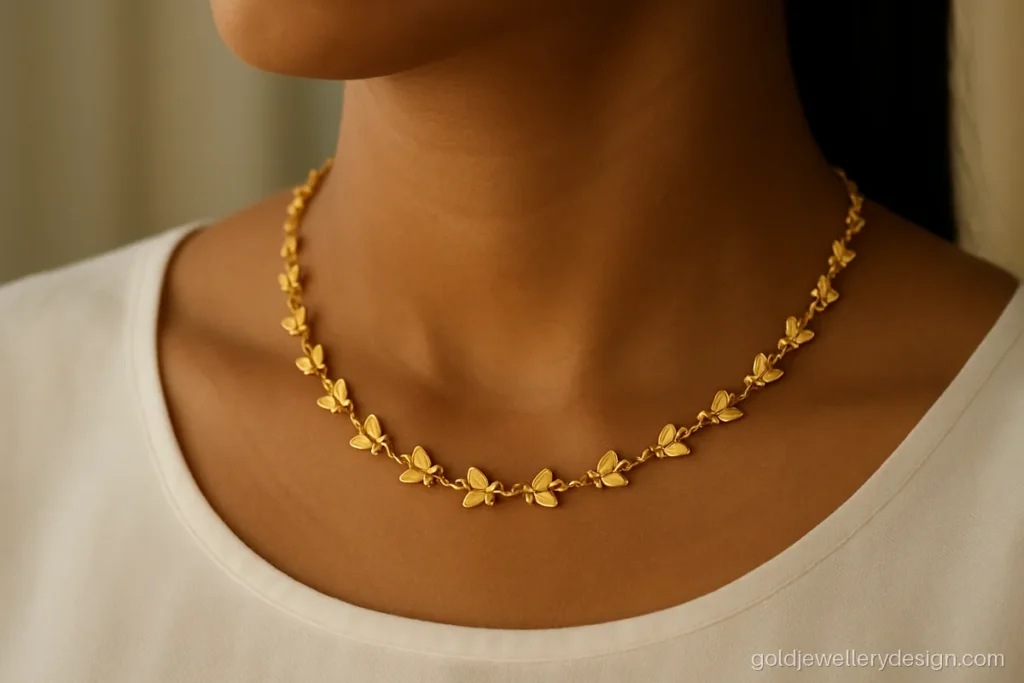 Girls gold chain design with small butterfly links at short choker length