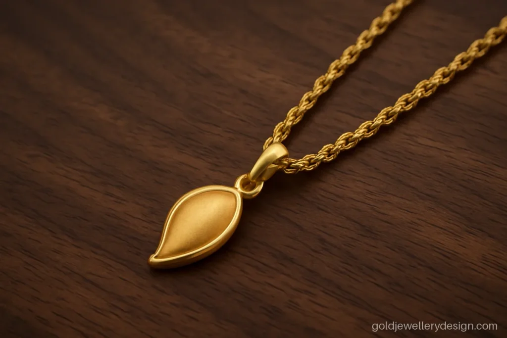 Rope link gold chain with a small kairi mango pendant in a matte finish