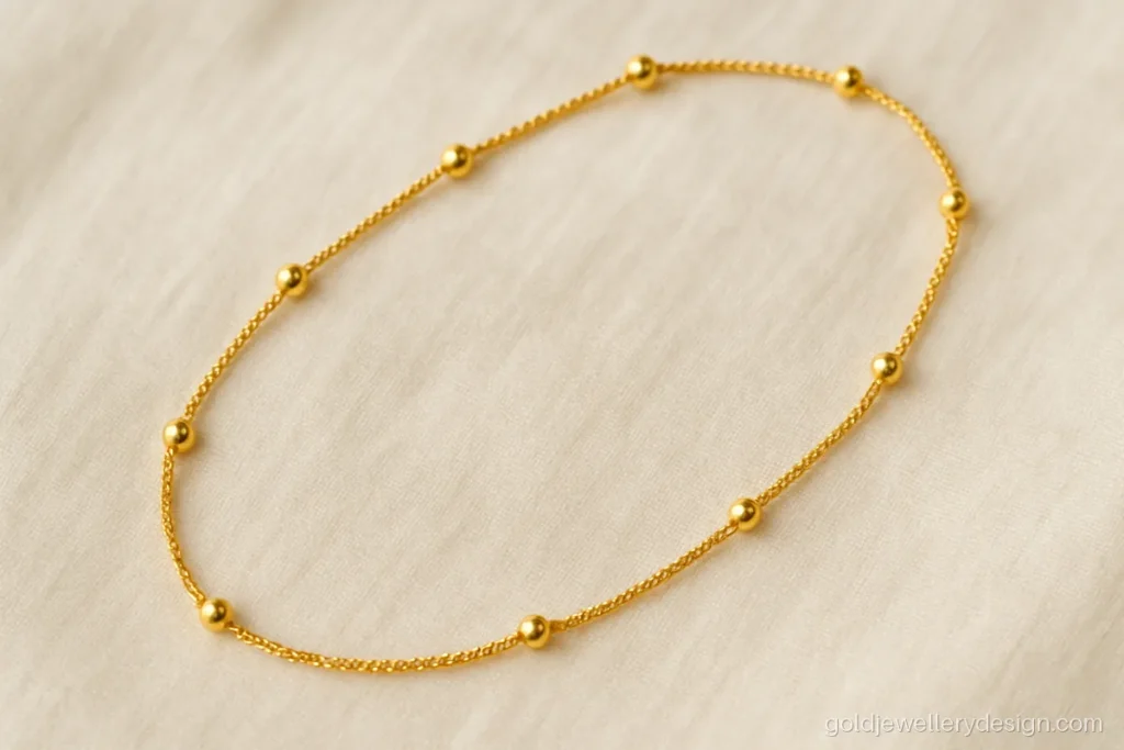 Long ball station gold chain design with polished beads every inch
