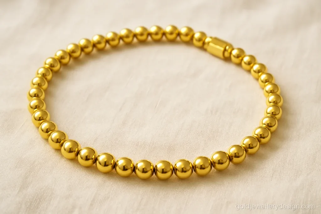 Simple gold choker design with one row of hollow polished beads on a flexible band