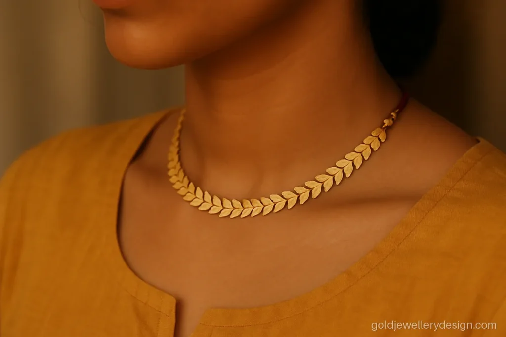 Light weight gold choker with linked matte leaf shapes and a thread adjuster