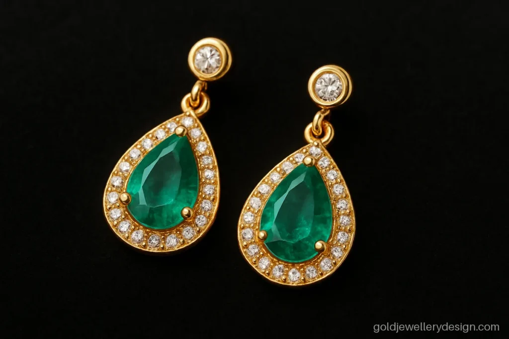 Women's earrings gold design with an emerald teardrop inside a white CZ halo