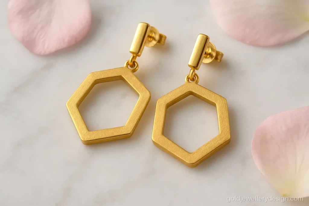 Gold earrings new design with a matte hexagon drop on a short bar