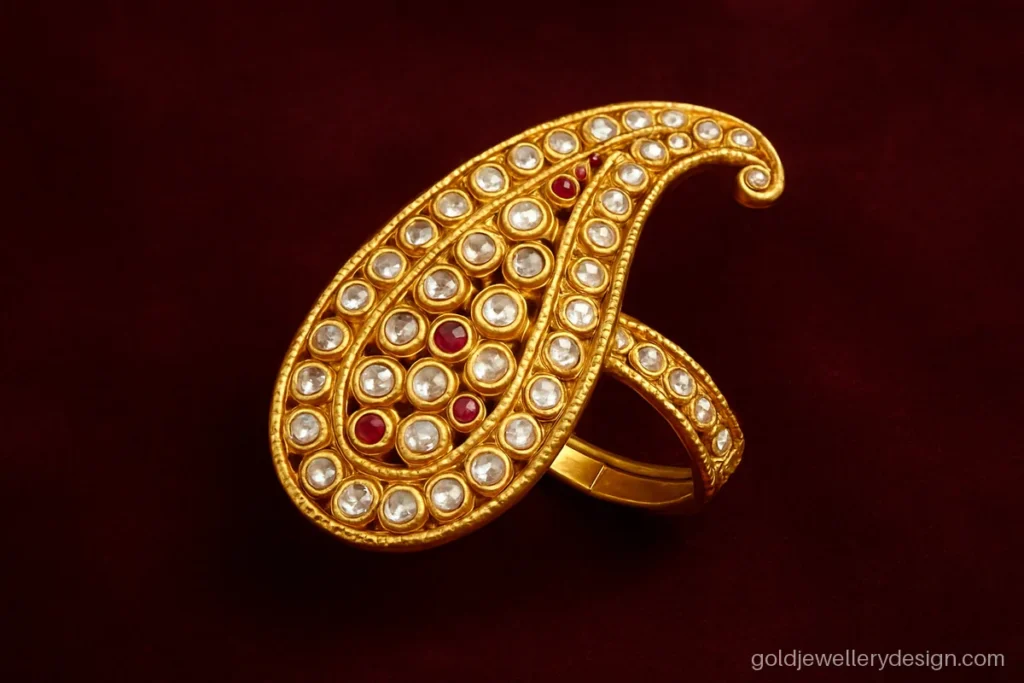 Full finger bridal big gold ring design shaped like a paisley with small stones