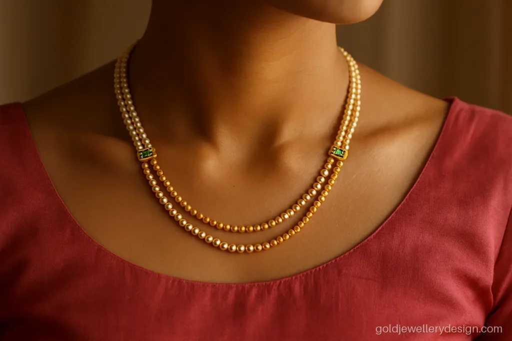 Layered gold haar design with pearl and gold strands worn with a silk blouse