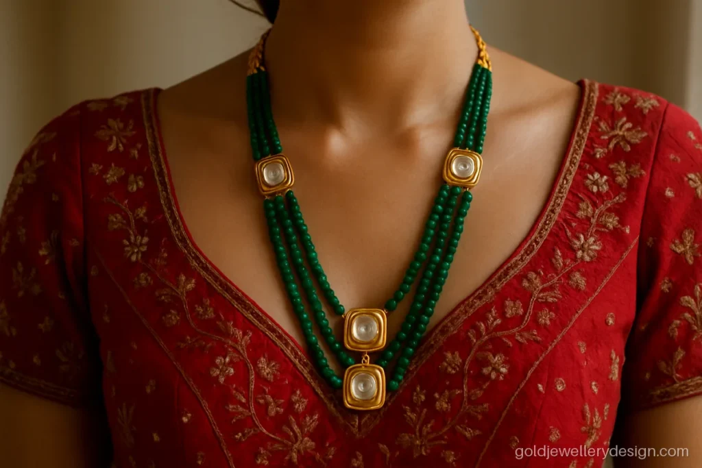Bridal gold haar design with polki-look stones and emerald beads worn with a lehenga