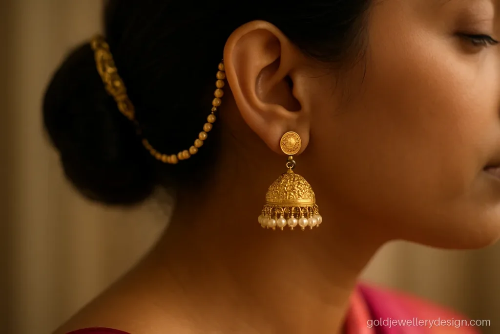 Gold chain jhumka design with a pearl sahara chain that clips into the hair
