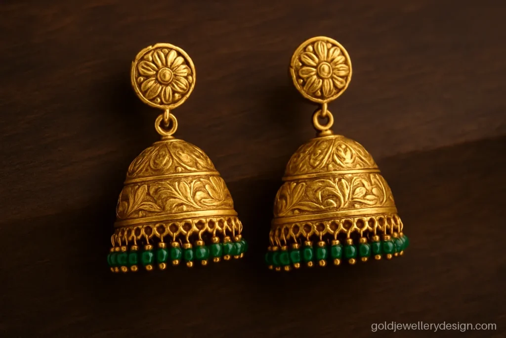 Jhumka gold design with green emerald bead fringe and engraved bell