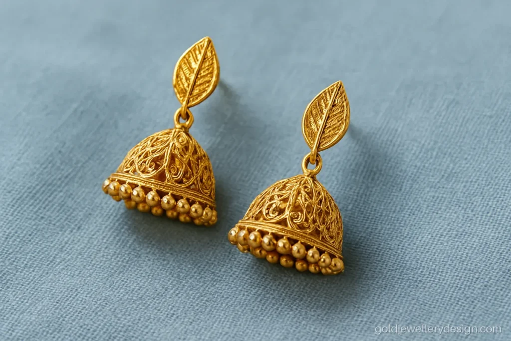 Gold jhumka design new with open filigree bell and leaf stud