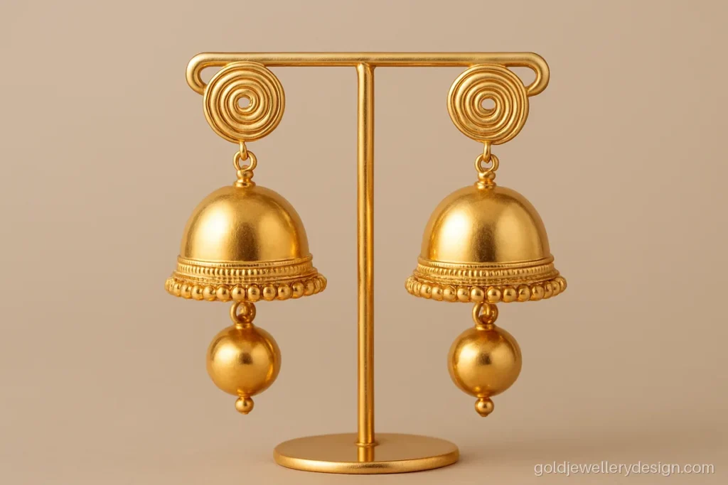 Light gold jhumka with hollow bell and wire stud that looks bigger than it weighs