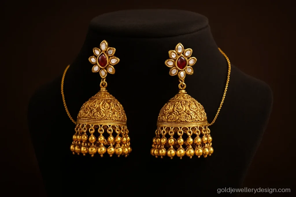 Bridal gold jhumka with kundan style stones and a sahara ear chain