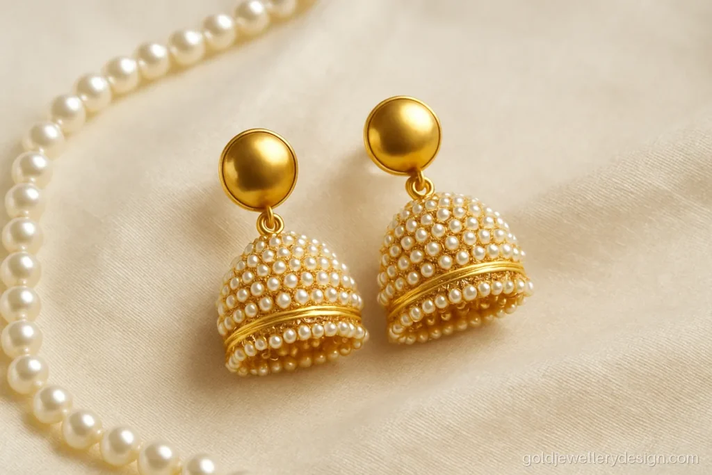 Gold jhumka with pearl cluster bell and round stud for festive wear