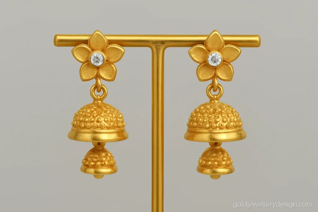 Gold jhumki design with five petal flower stud and a tiny white stone