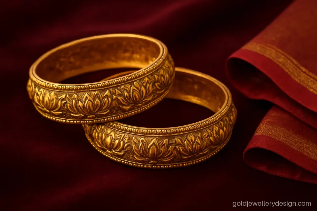 Traditional gold kangan design pair with broad band and carved lotus panels