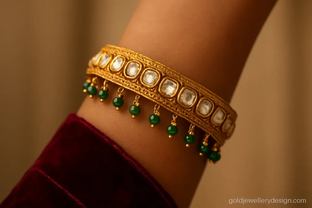 Bridal gold kada design with polki look uncut stones and emerald drops