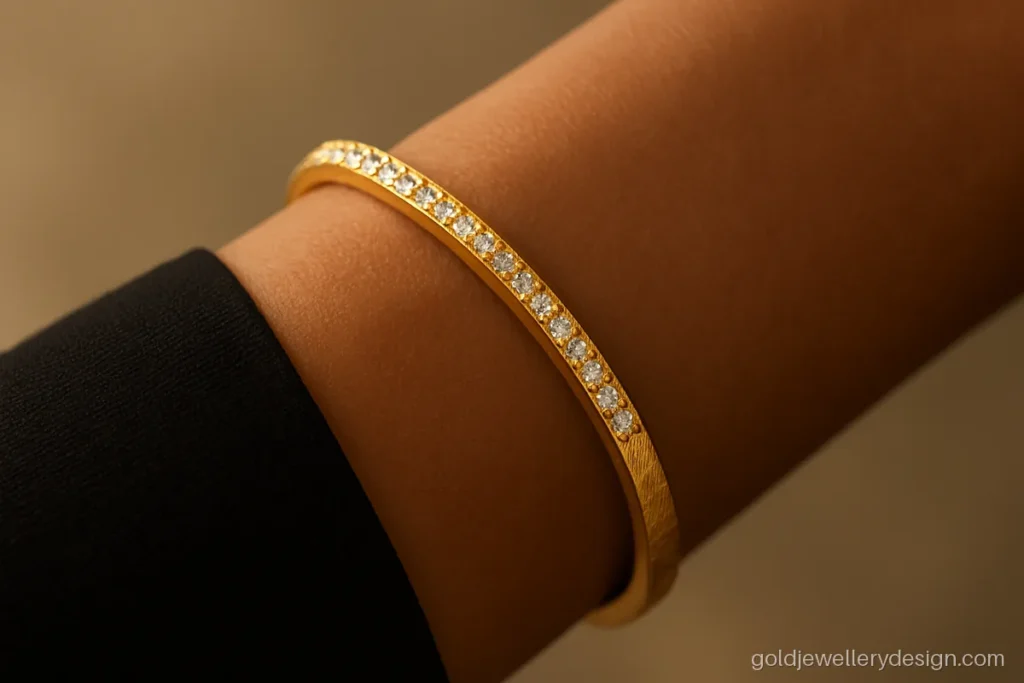 Single gold kada with one row of white stones and an open front