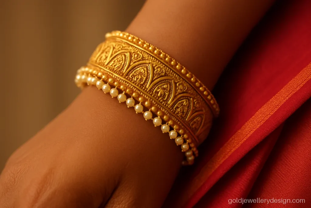 Kangan gold design with temple arch carving and small pearl edge