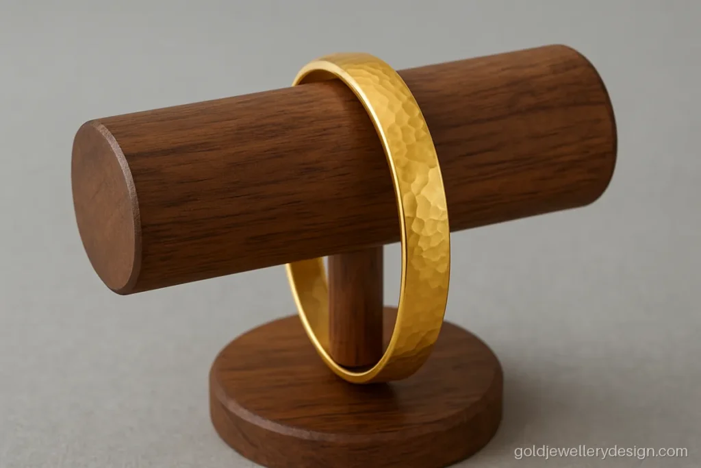 Unique gold kada design for ladies with a flat hammered band