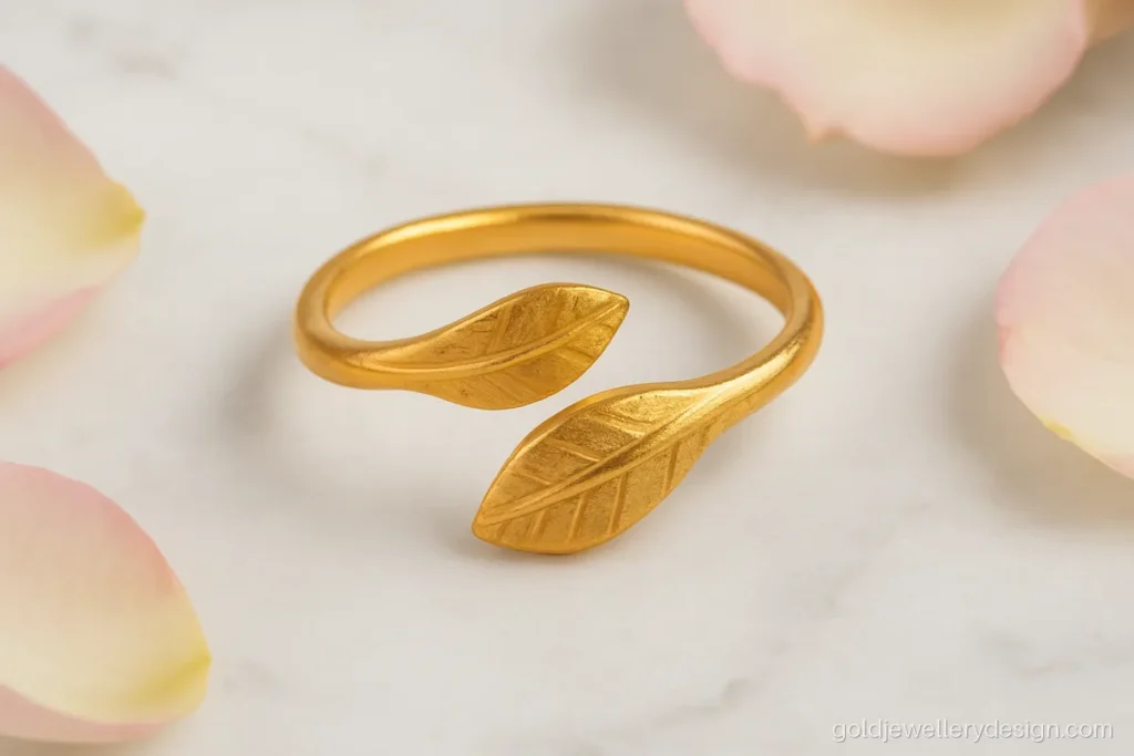 Open wrap ring gold design with two leaf ends meeting on the finger