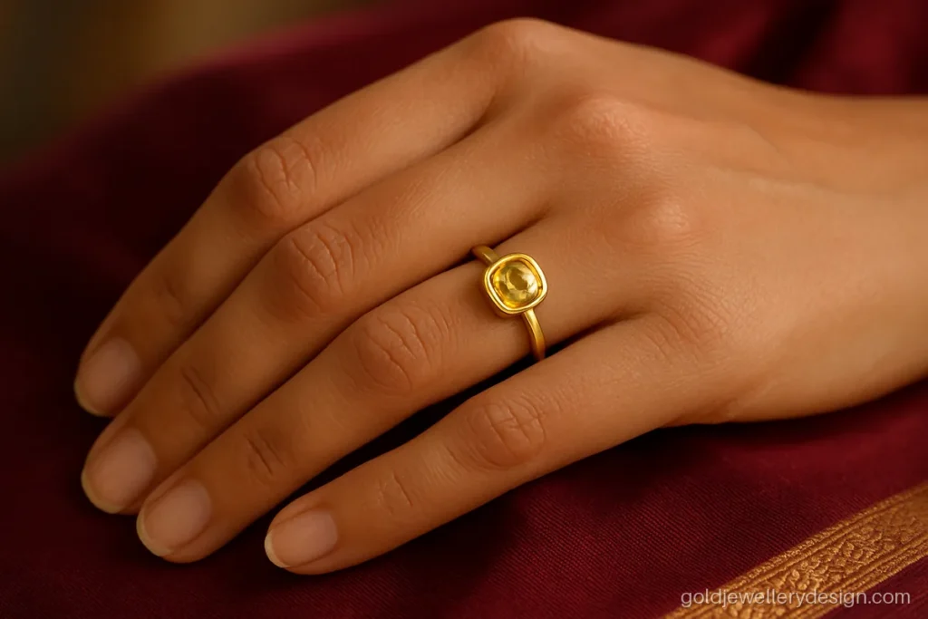 Ladies gold ring design with a yellow sapphire set in a smooth bezel