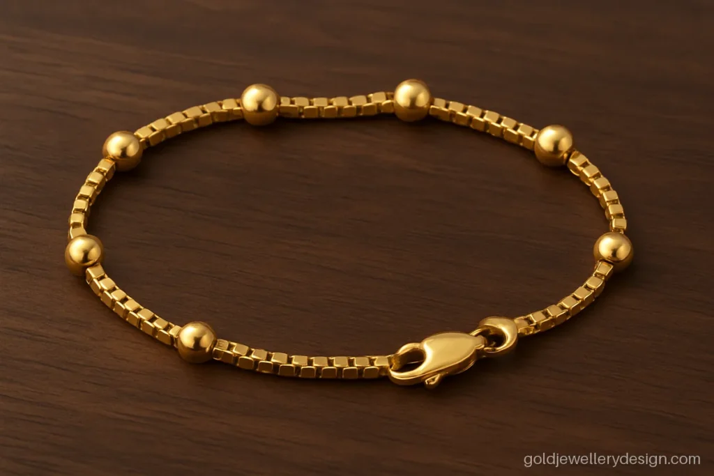 Gold bracelet design for man or teen with polished balls on a box link