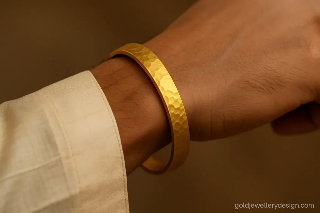 Hammered matte gold kada for men worn with a kurta sleeve