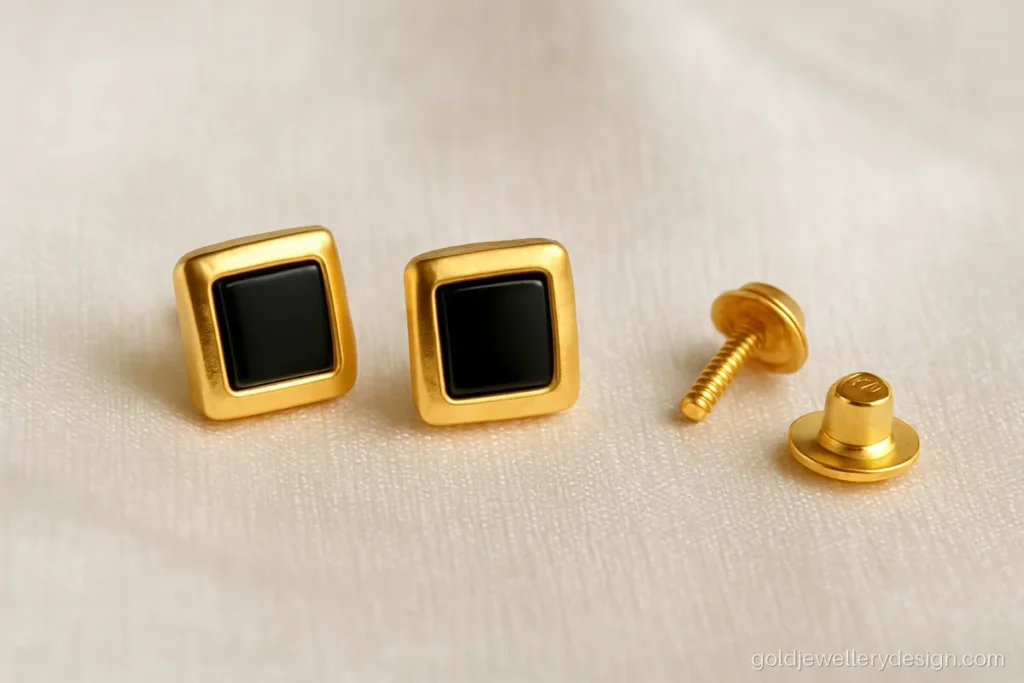 Gold earrings design for men with small square studs, a black stone and screw back