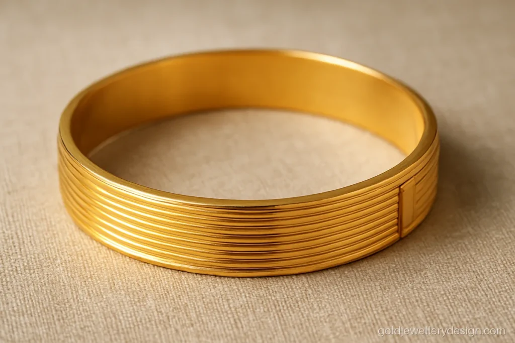 Wide hollow gold kada for men with a screw opening and engraved lines