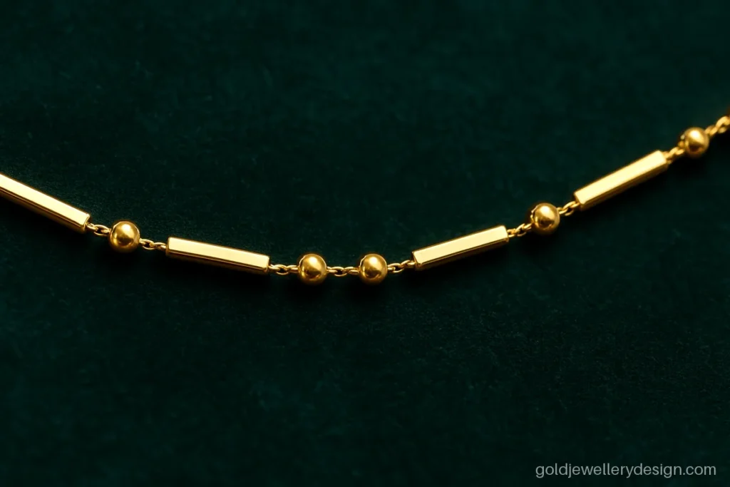 Gold chain design for boys with small polished balls between short bars
