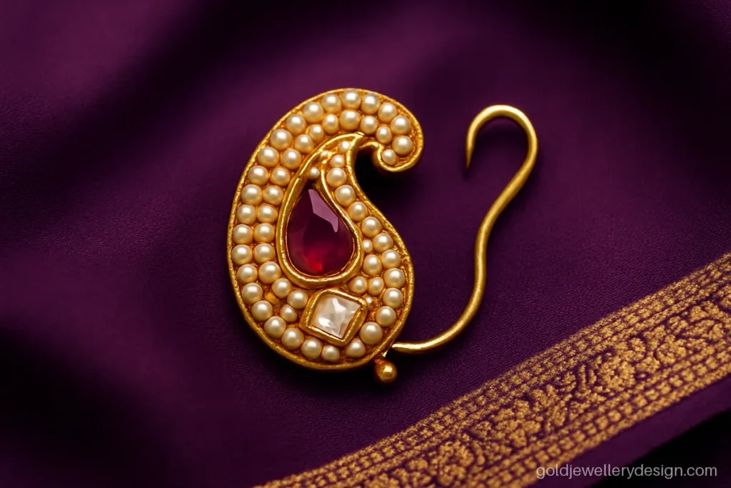 Pearl studded curved nath design gold with paisley shape and ruby centre