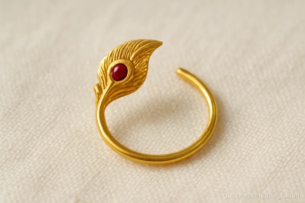 Small gold mor nath with single peacock feather and ruby eye