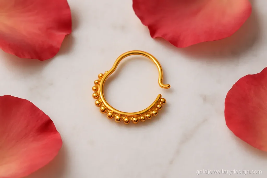 Nathiya gold design shaped like a half moon with dotted edge
