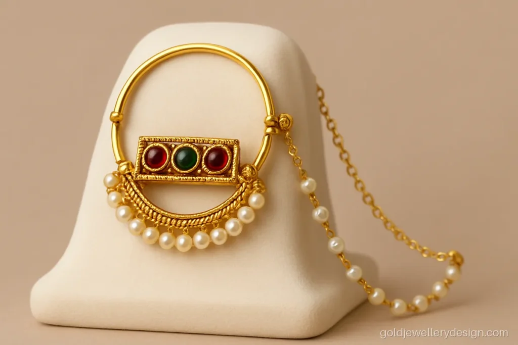 Pahadi gold nath with red and green stone panel and pearl lower curve