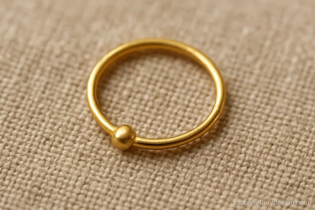 Simple small nath design gold hoop with one tiny bead
