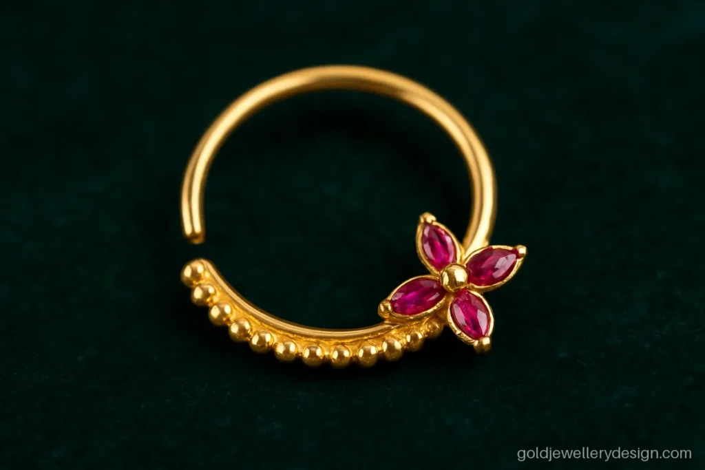 2 gram gold nath design with a small ruby flower on the ring