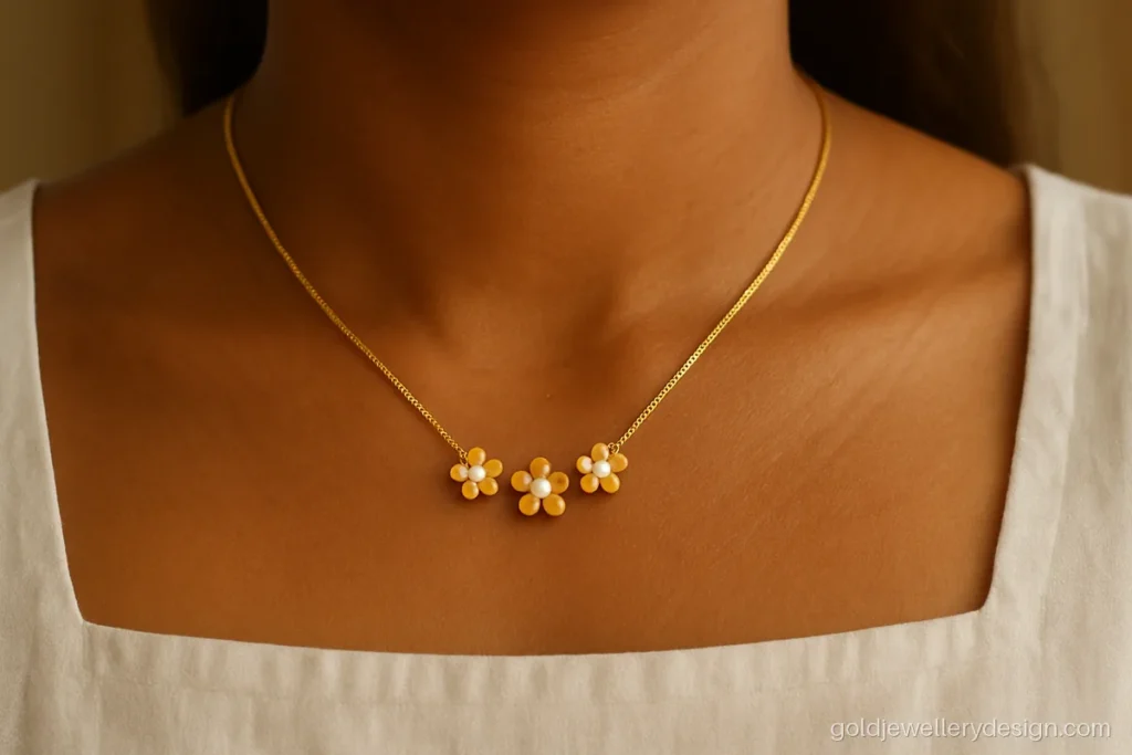 Young woman wearing a small floral gold necklace with pearls and a cotton top