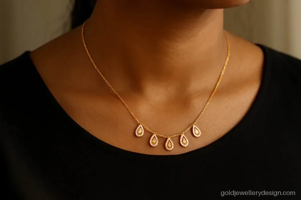 Gold necklace design light weight with small CZ tear drops worn with a dress